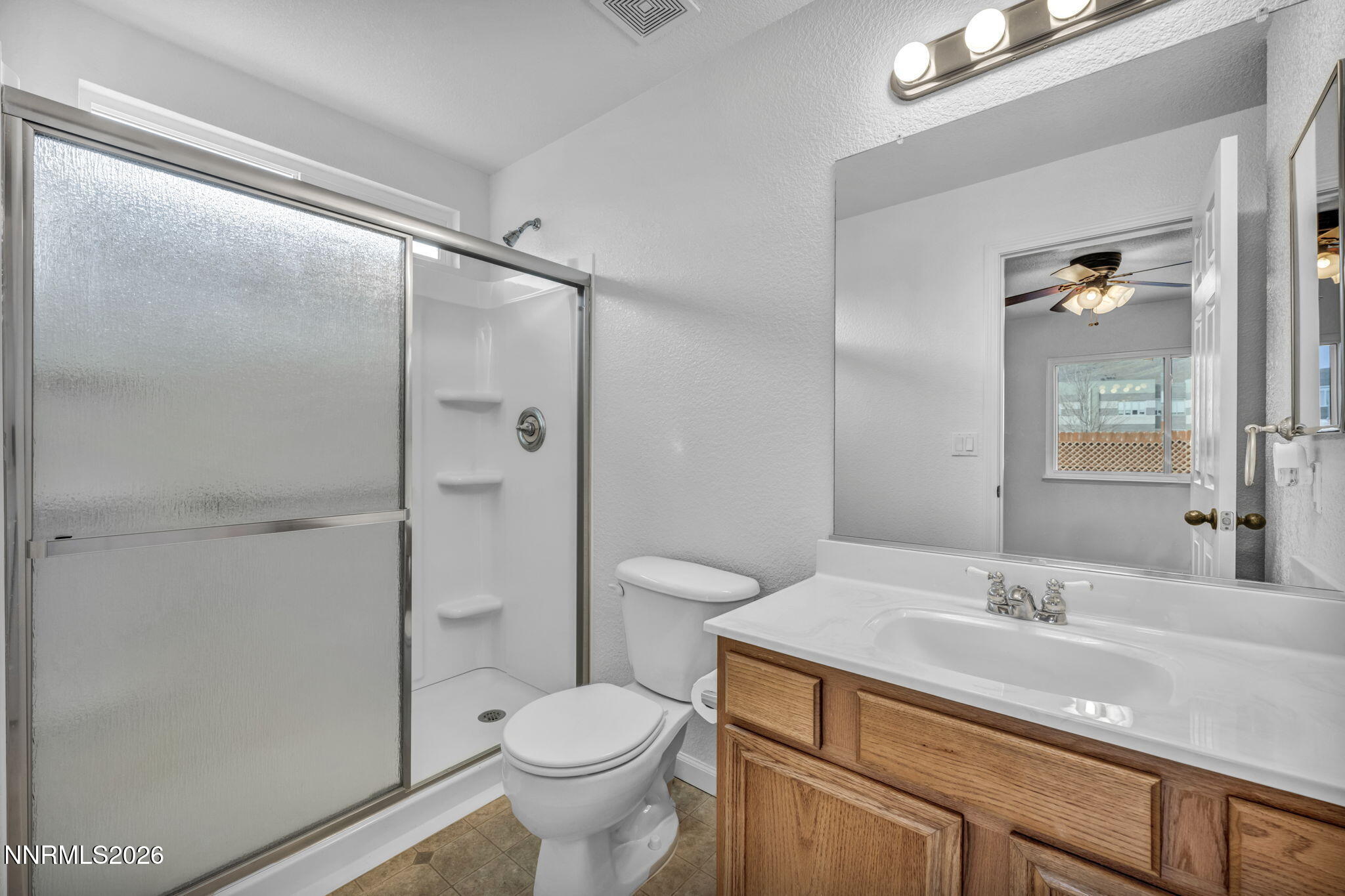 17725 Live Oak Court Reno, NV 89508 - Photo 36 of 44 a bathroom with a granite countertop sink toilet a mirror and shower