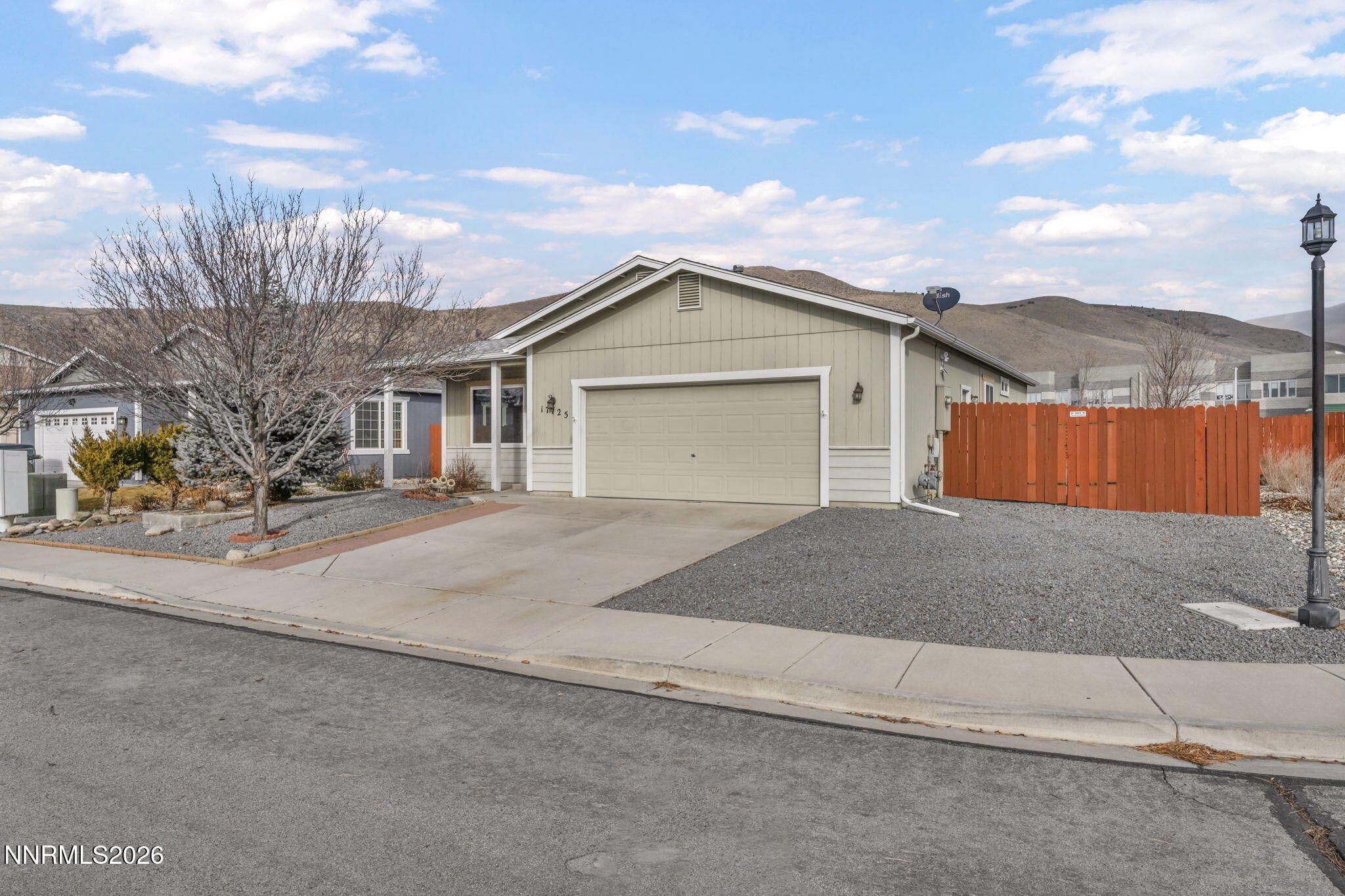 17725 Live Oak Court Reno, NV 89508 - Photo 4 of 44 a front view of a house with a yard and garage
