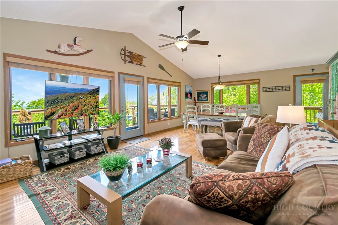 1078 Charter Hills Road Beech Mountain, NC 28604 - Photo 17 of 50 a living room with furniture ceiling fan and a rug