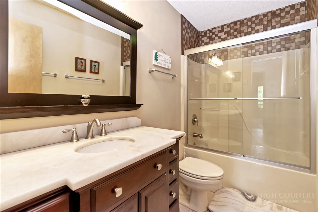 1078 Charter Hills Road Beech Mountain, NC 28604 - Photo 21 of 50 a bathroom with a sink a toilet and shower