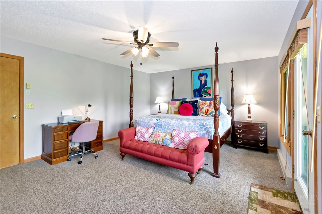 1078 Charter Hills Road Beech Mountain, NC 28604 - Photo 23 of 50 a bedroom with furniture and a chandelier fan