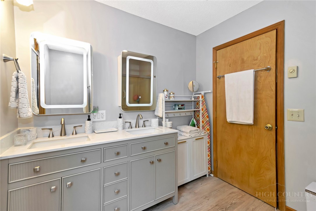 1078 Charter Hills Road Beech Mountain, NC 28604 - Photo 26 of 50 a bathroom with a double vanity sink and mirror