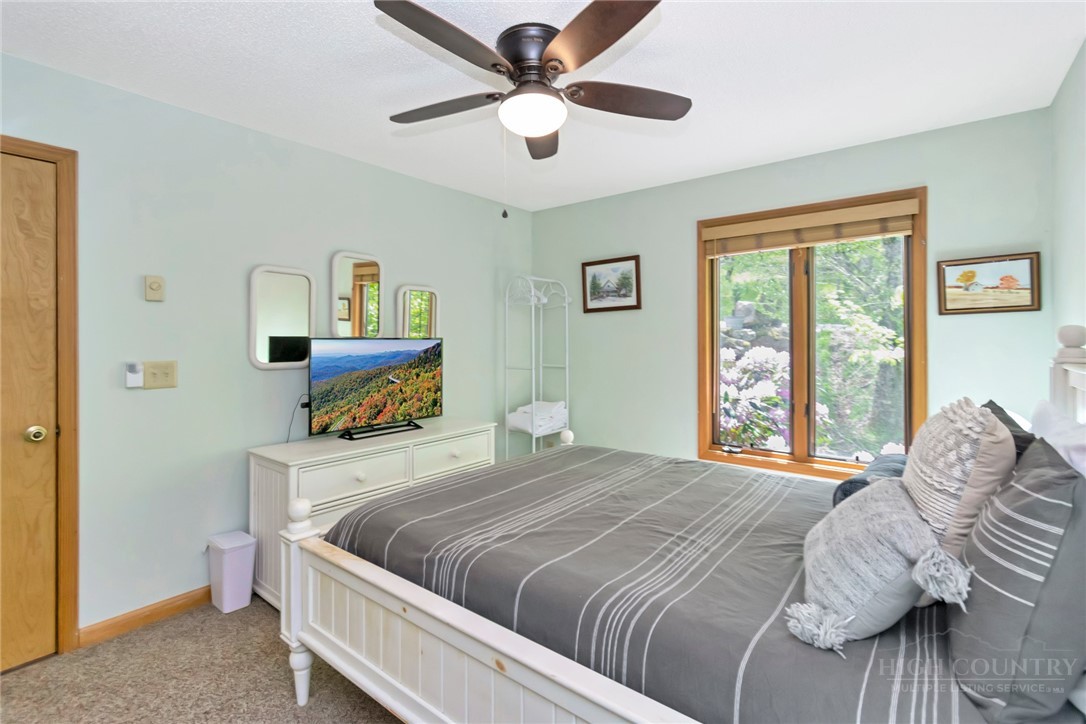 1078 Charter Hills Road Beech Mountain, NC 28604 - Photo 32 of 50 a bedroom with a bed and a window
