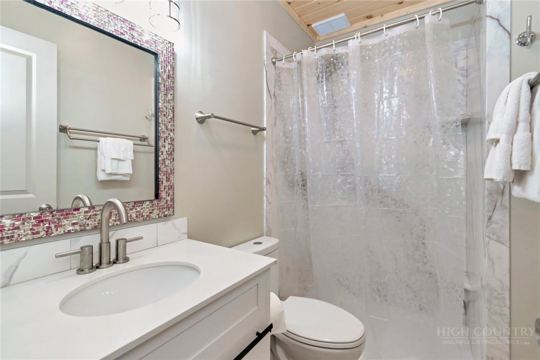 1078 Charter Hills Road Beech Mountain, NC 28604 - Photo 38 of 50 a bathroom with a sink toilet and shower