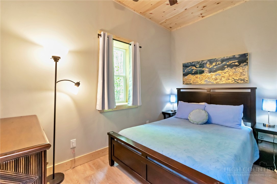 1078 Charter Hills Road Beech Mountain, NC 28604 - Photo 39 of 50 a bedroom with a bed and a window