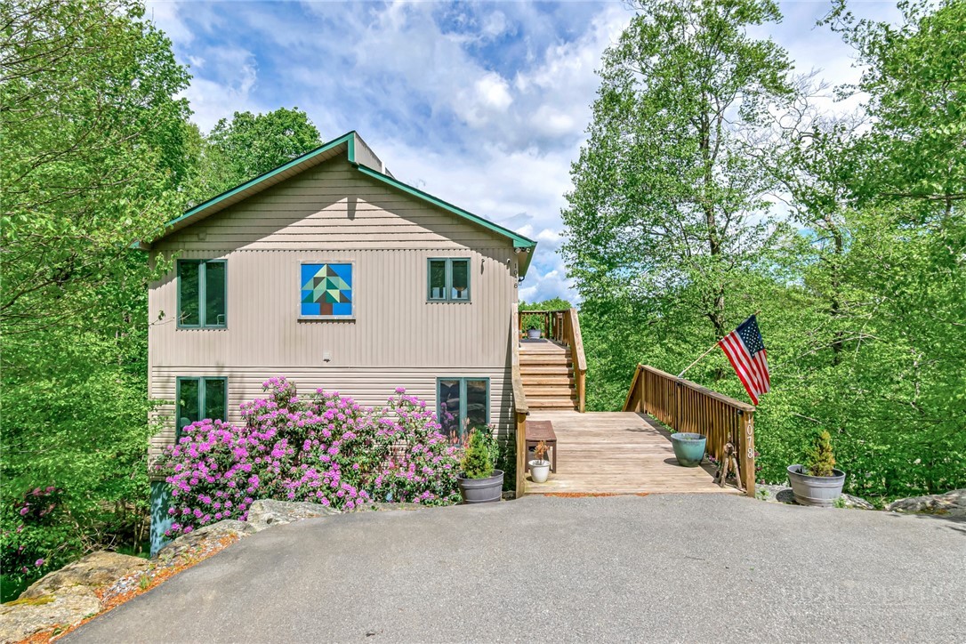 1078 Charter Hills Road Beech Mountain, NC 28604 - Photo 4 of 50 a front view of a house with a yard and garage