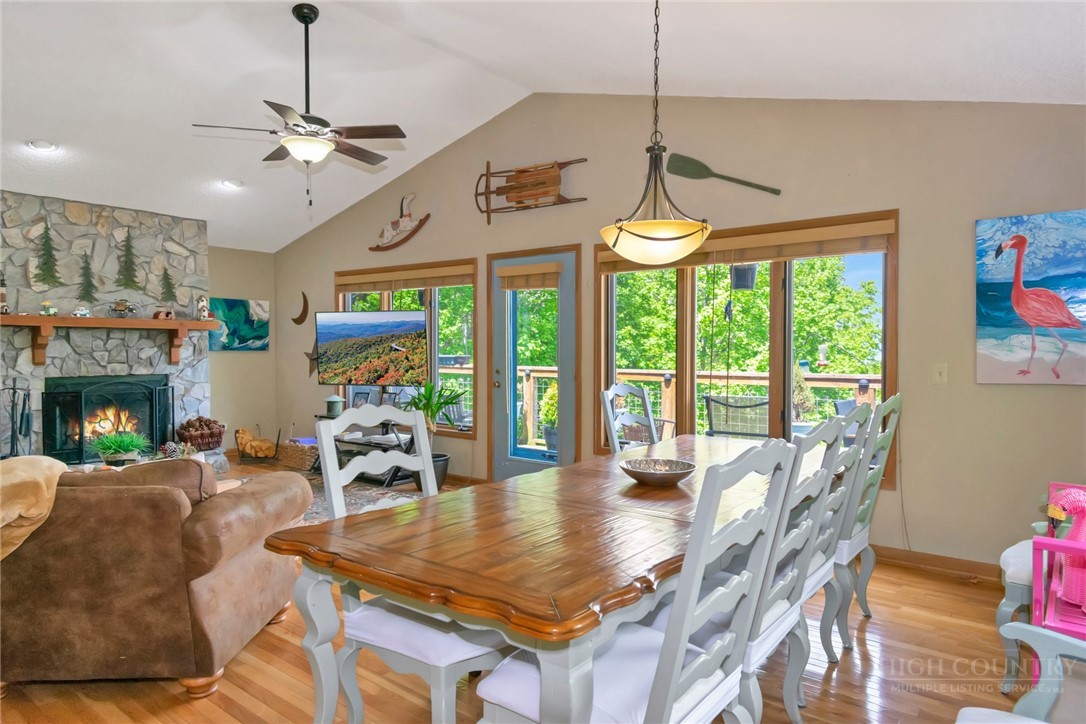 1078 Charter Hills Road Beech Mountain, NC 28604 - Photo 10 of 50 a dining room with furniture a chandelier and wooden floor