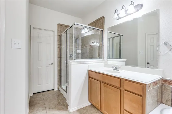 a bathroom with a sink vanity and a mirror