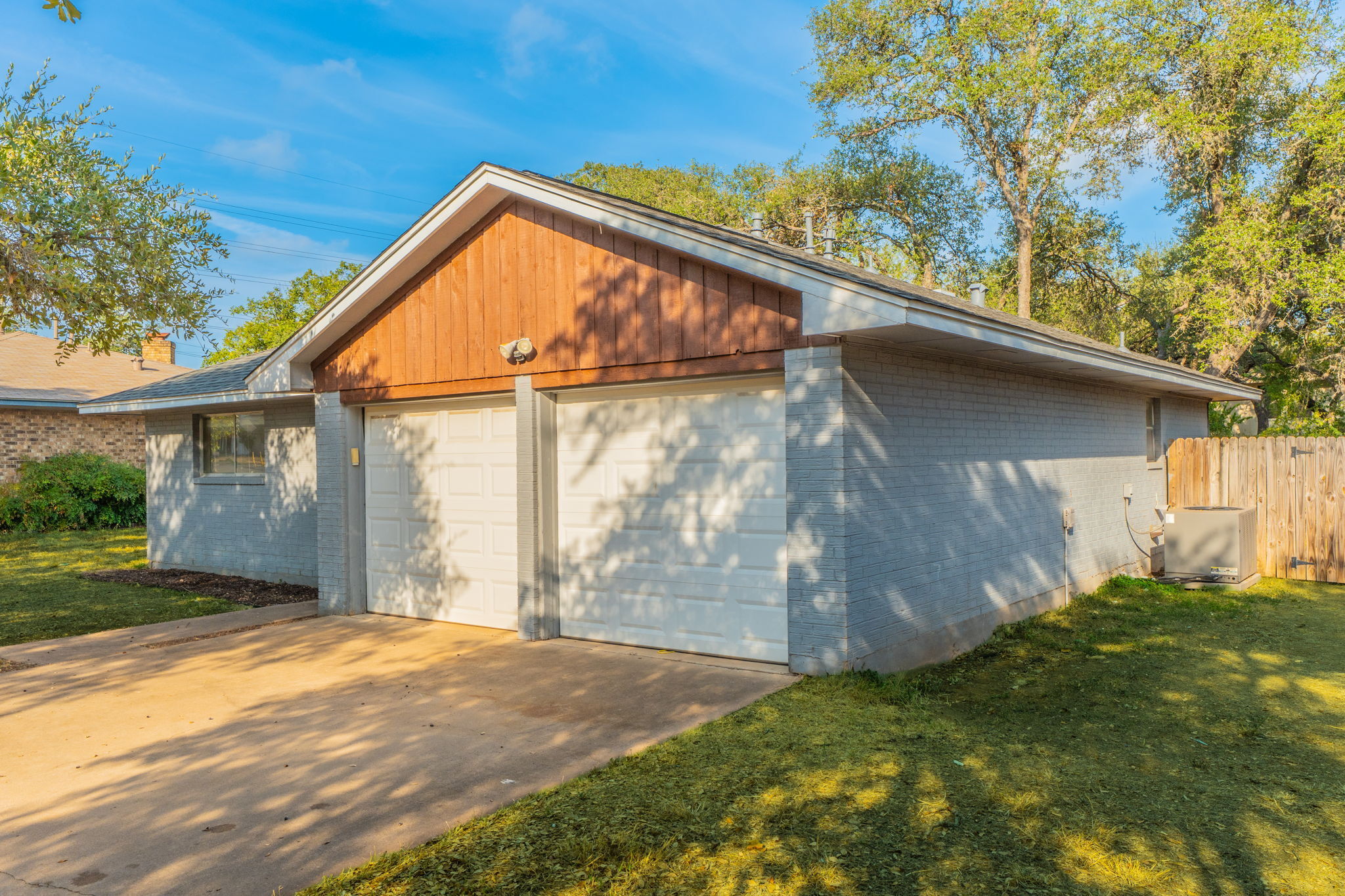 5628 Wagon Train Road Austin, TX 78749 - Photo 23 of 26 A spacious driveway leads to a classic two-car garage with brick siding.