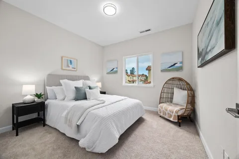 a bedroom with furniture and a flat screen tv