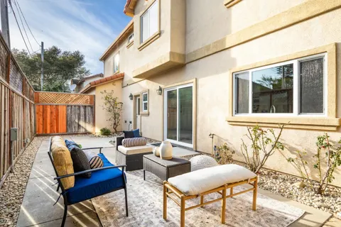 a view of a patio with couches and a table and chairs with wooden floor