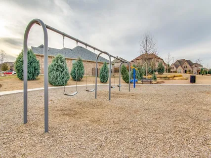 a view of a park with iron fence