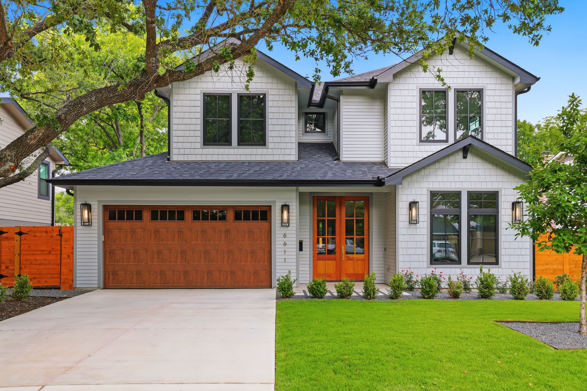6611 Lexington Road Austin, TX 78757 - Photo 2 of 37 Contemporary two-story residence featuring light gray siding and dark trim accents