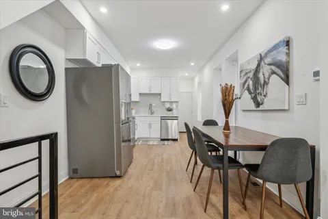 a view of a kitchen with dining table and chairs