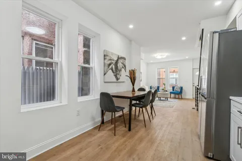 a view of a dining room with furniture and wooden floor