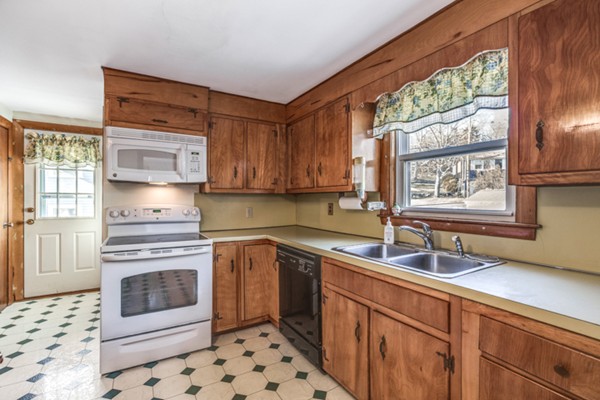 24 Station Road Salem, MA 01970 - Photo 10 of 25 a kitchen with stainless steel appliances a stove a sink and a microwave