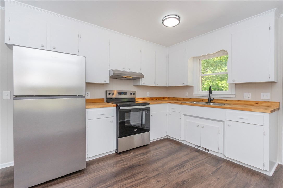113 Linda Lane Honea Path, SC 29654 - Photo 12 of 36 This newly renovated kitchen boasts bright cabinetry, modern appliances, and a durable flooring.