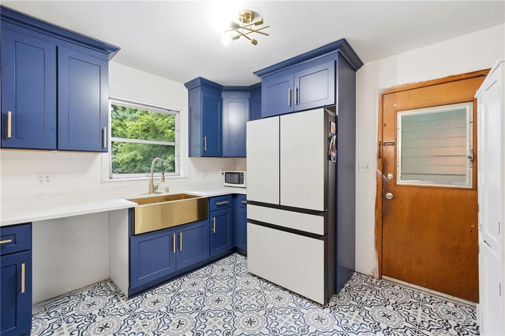 430 Church Road Southwest Marietta, GA 30060 - Photo 11 of 35 a kitchen with stainless steel appliances granite countertop a refrigerator and a sink