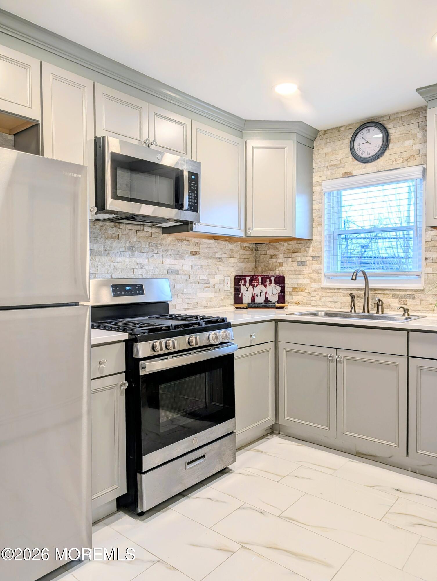 151 Wyckoff Road Eatontown, NJ 07724 - Photo 11 of 17 a kitchen with stainless steel appliances granite countertop a stove a microwave and a refrigerator