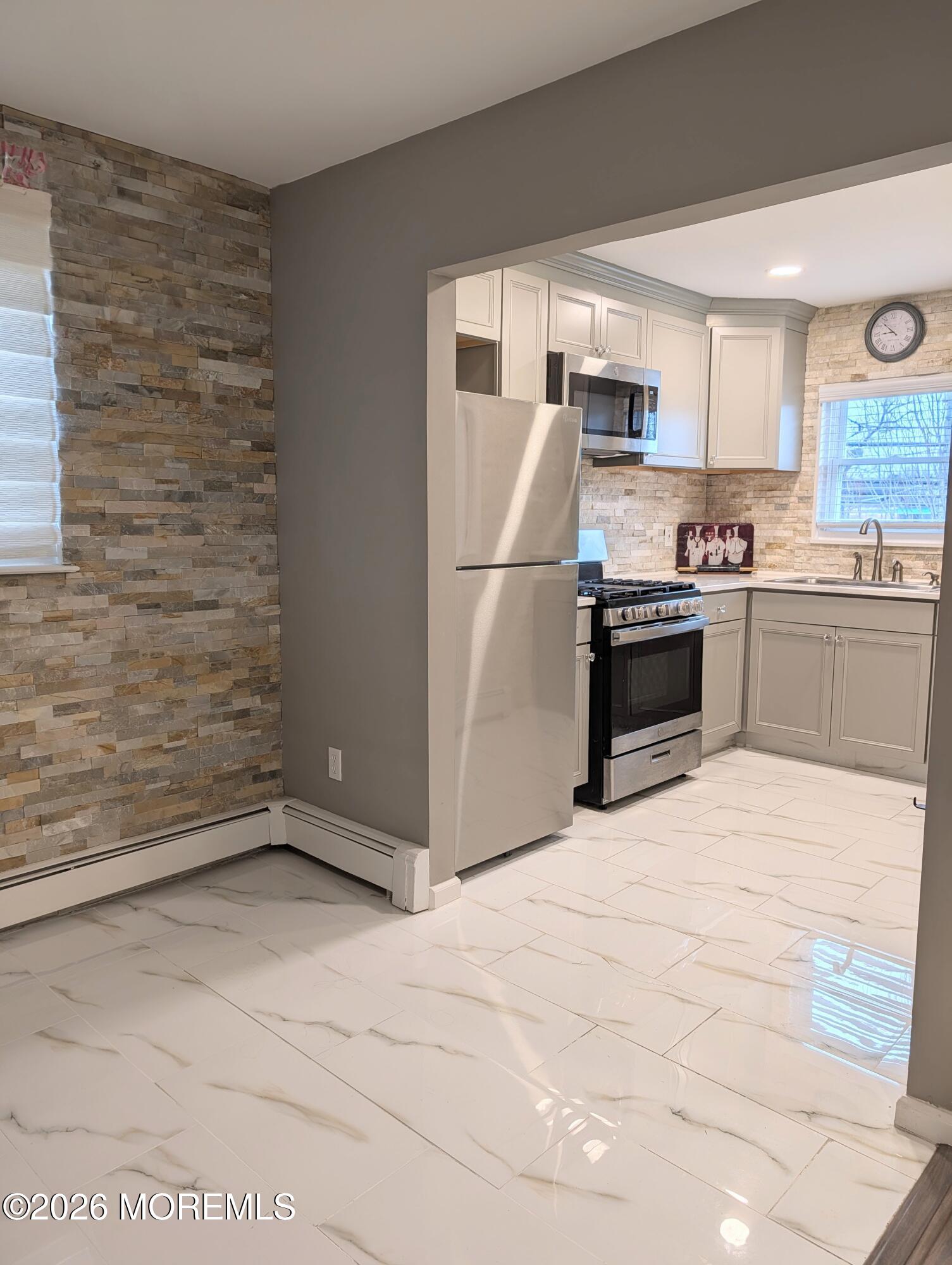 151 Wyckoff Road Eatontown, NJ 07724 - Photo 15 of 17 a kitchen with granite countertop a refrigerator and a stove top oven