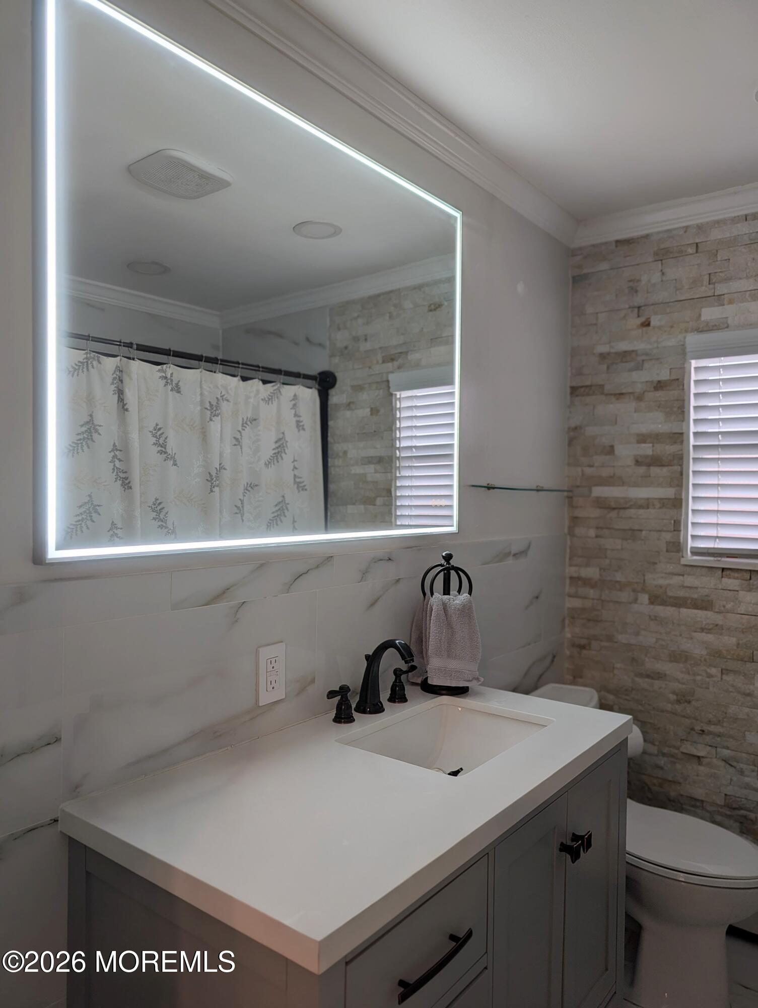 151 Wyckoff Road Eatontown, NJ 07724 - Photo 16 of 17 a bathroom with a sink and a mirror