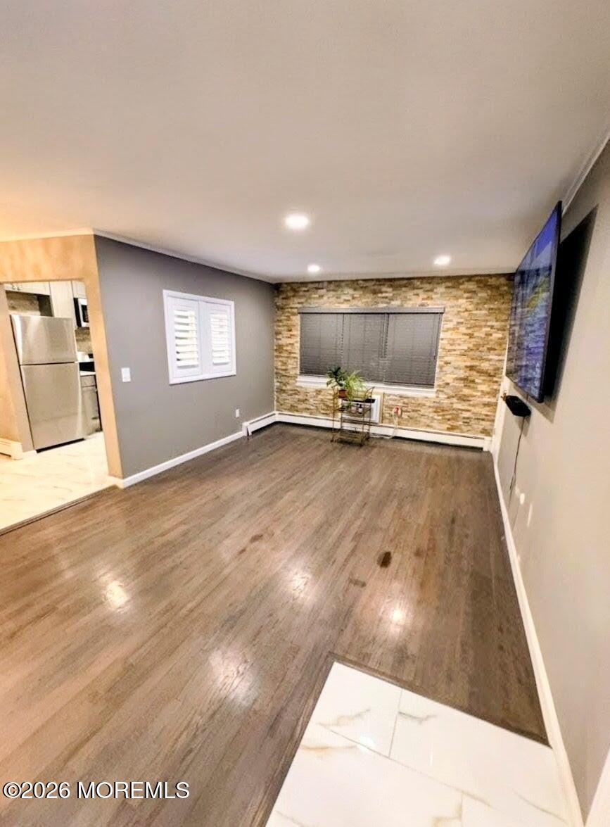151 Wyckoff Road Eatontown, NJ 07724 - Photo 7 of 17 a view of a livingroom with wooden floor and a fireplace