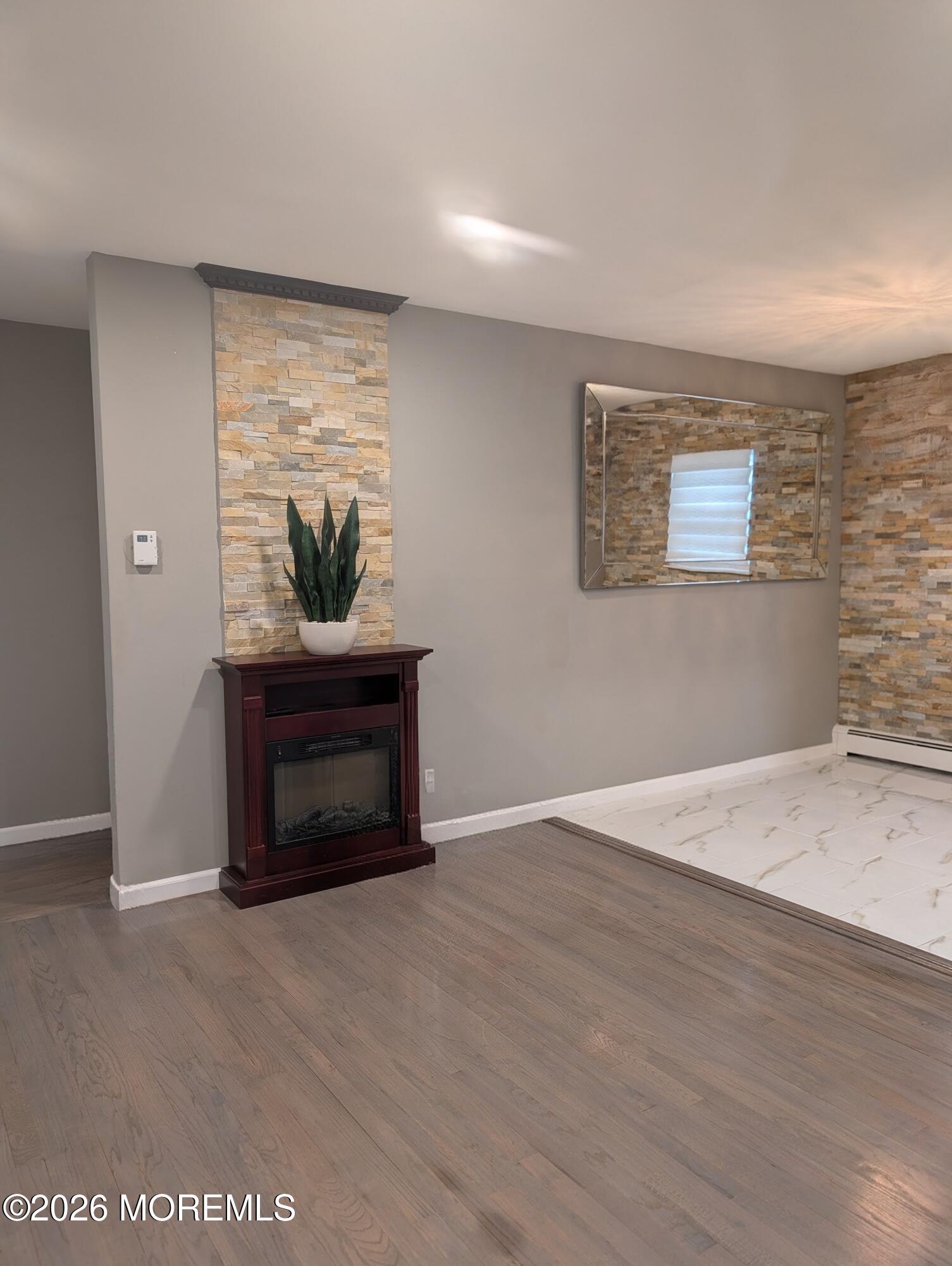 151 Wyckoff Road Eatontown, NJ 07724 - Photo 9 of 17 a living room with furniture and a fireplace