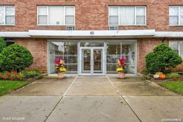 a view of a brick building with a outdoor seating space