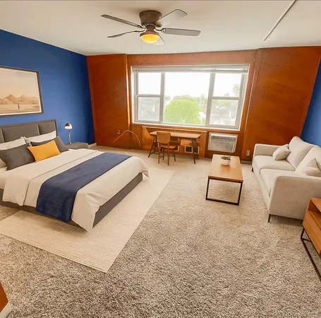 a bedroom with bed and a large window