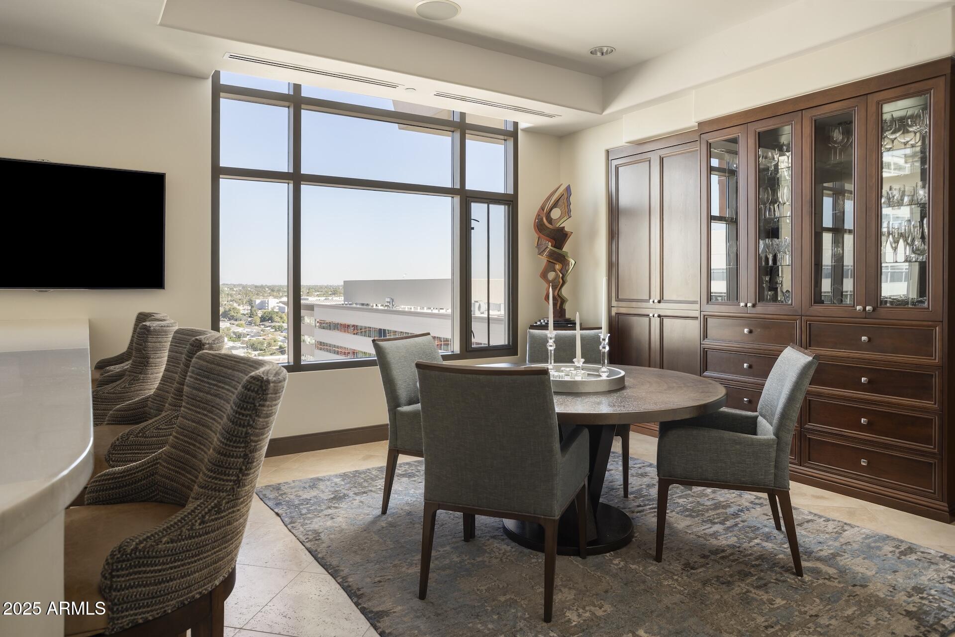 2211 East Camelback Road, Unit 1203 Phoenix, AZ 85016 - Photo 12 of 39 a view of a dining room with furniture window and outside view