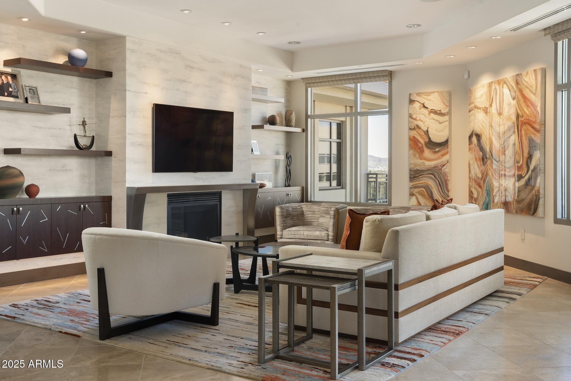 2211 East Camelback Road, Unit 1203 Phoenix, AZ 85016 - Photo 14 of 39 a living room with fireplace furniture and a flat screen tv