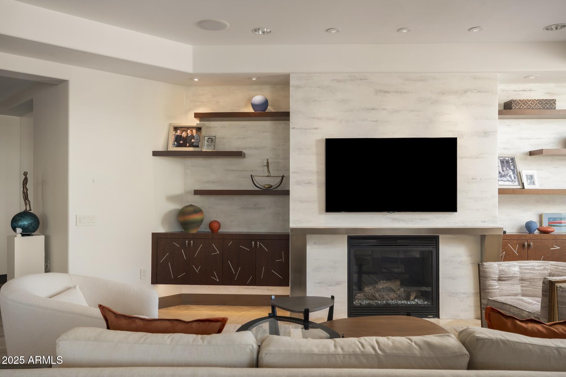 2211 East Camelback Road, Unit 1203 Phoenix, AZ 85016 - Photo 16 of 39 a living room with furniture and a fireplace