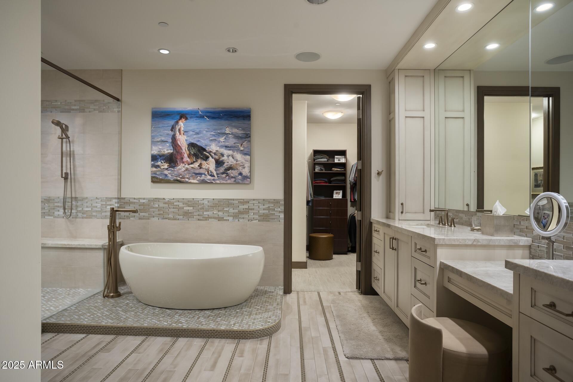 2211 East Camelback Road, Unit 1203 Phoenix, AZ 85016 - Photo 18 of 39 a spacious bathroom with a double vanity sink a mirror and a bathtub