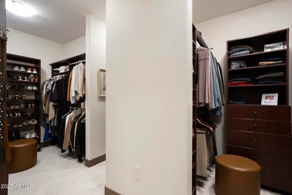 a spacious bathroom with a double vanity sink a mirror and a bathtub