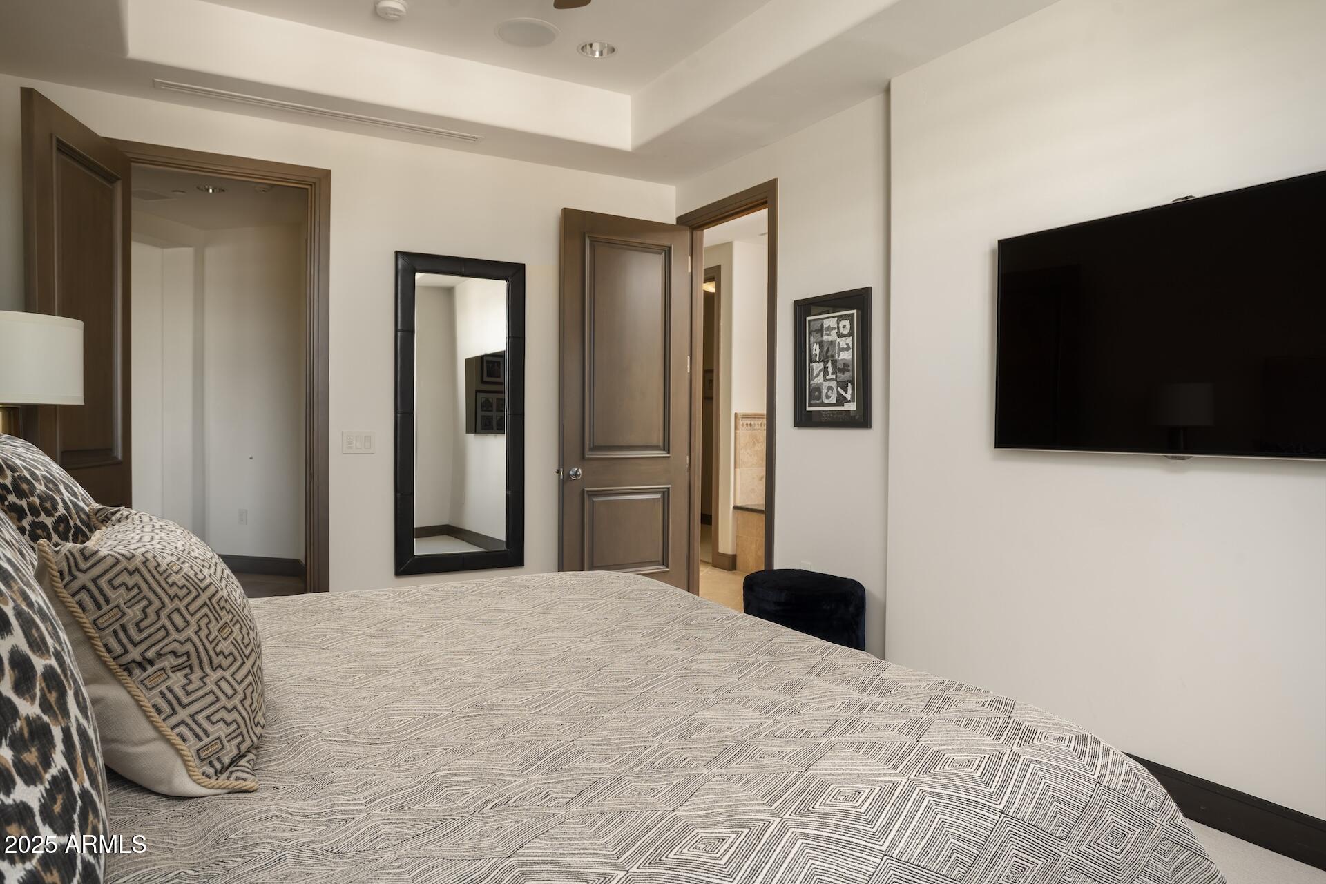 2211 East Camelback Road, Unit 1203 Phoenix, AZ 85016 - Photo 21 of 39 a bedroom with a bed tv and a window