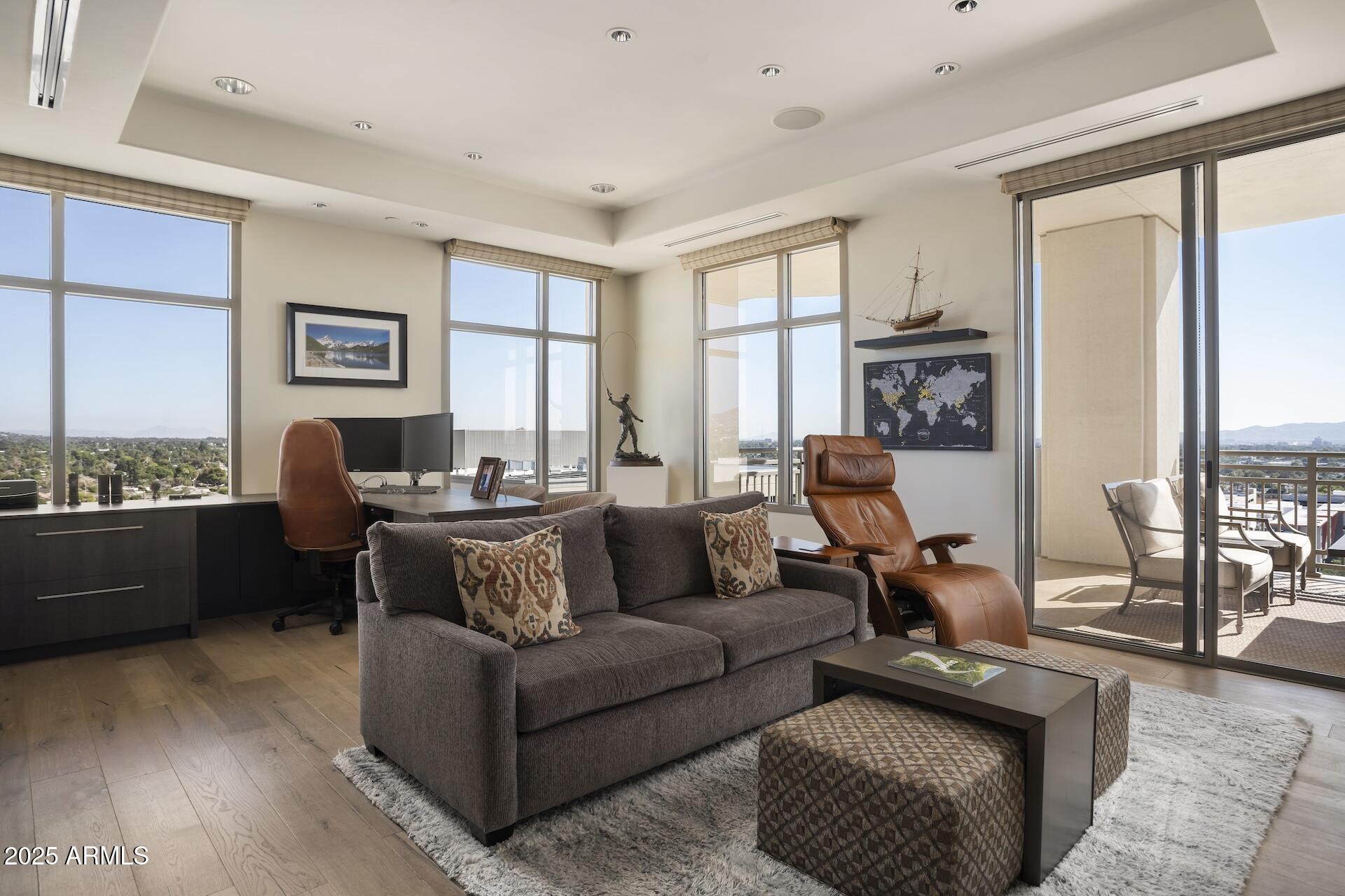 2211 East Camelback Road, Unit 1203 Phoenix, AZ 85016 - Photo 23 of 39 a living room with furniture and a flat screen tv