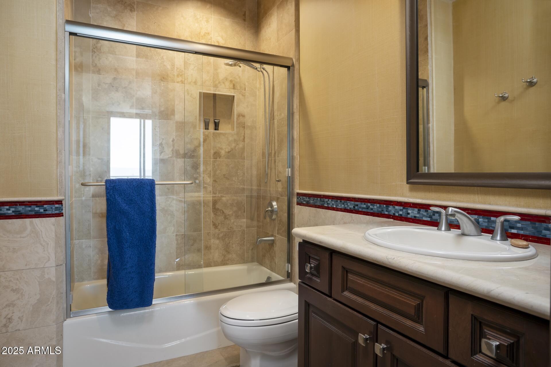 2211 East Camelback Road, Unit 1203 Phoenix, AZ 85016 - Photo 25 of 39 a bathroom with a sink a toilet and shower