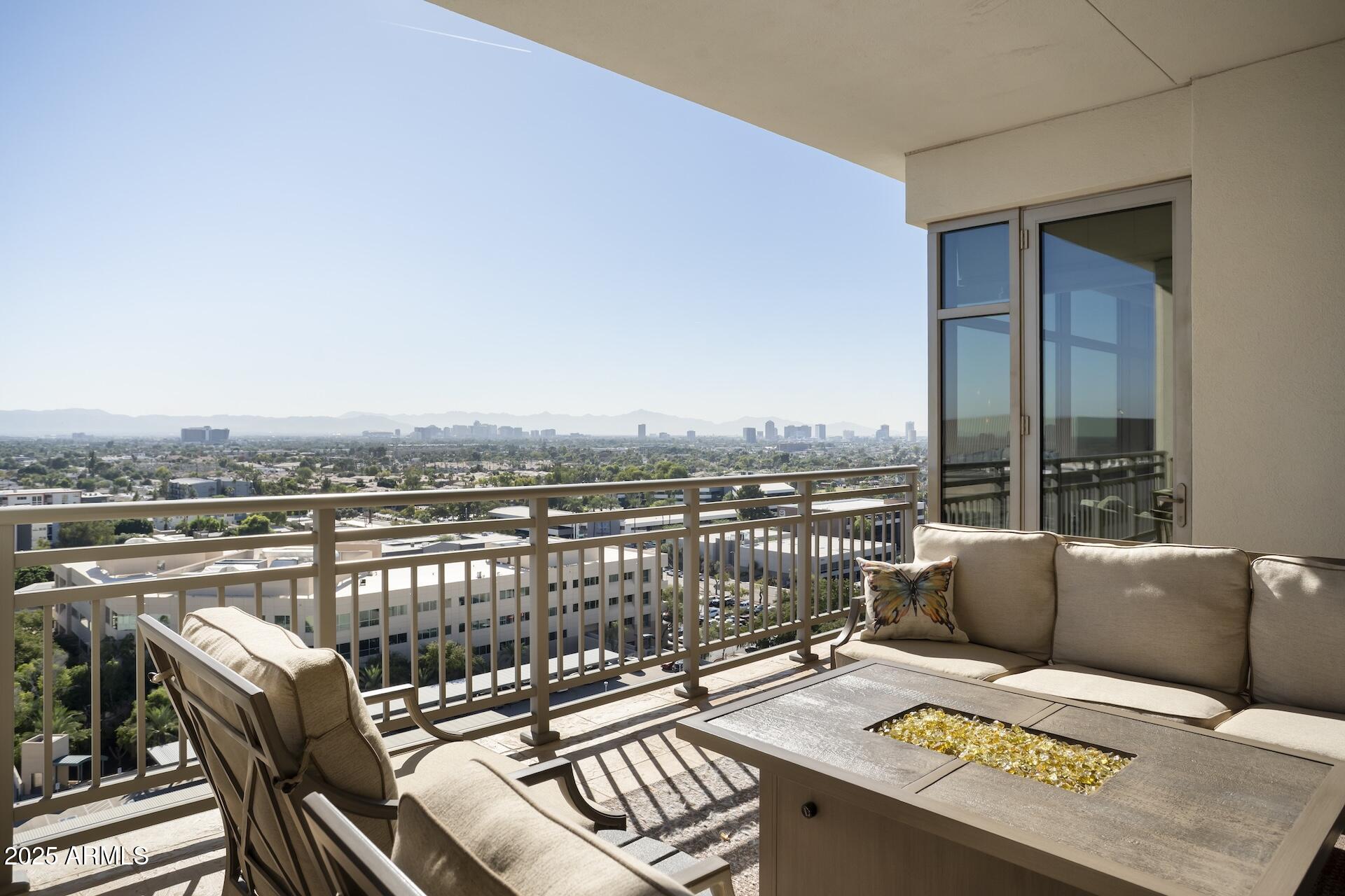 2211 East Camelback Road, Unit 1203 Phoenix, AZ 85016 - Photo 2 of 39 a balcony with furniture and a potted plant