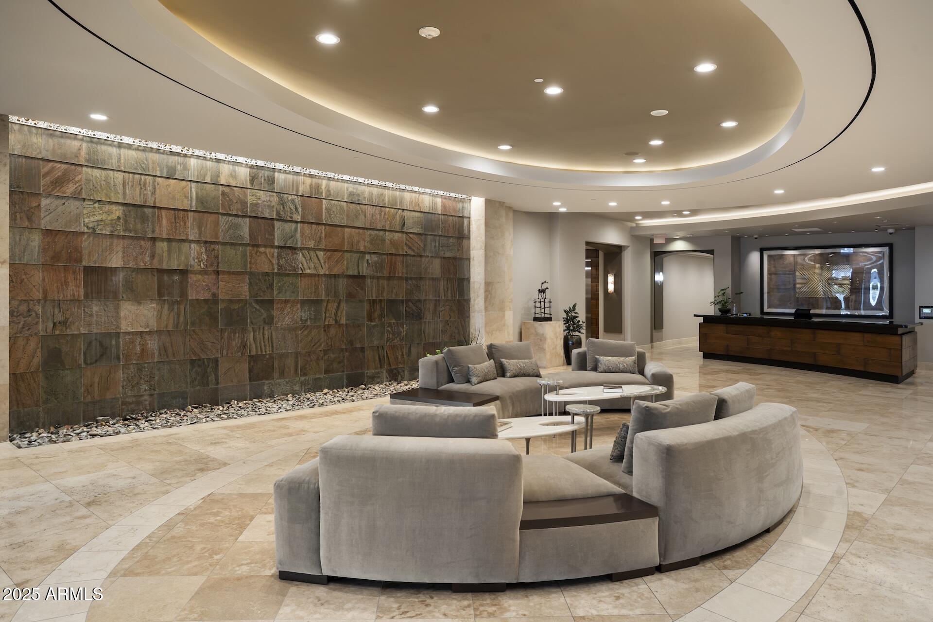 2211 East Camelback Road, Unit 1203 Phoenix, AZ 85016 - Photo 32 of 39 a living room with couches and a flat screen tv