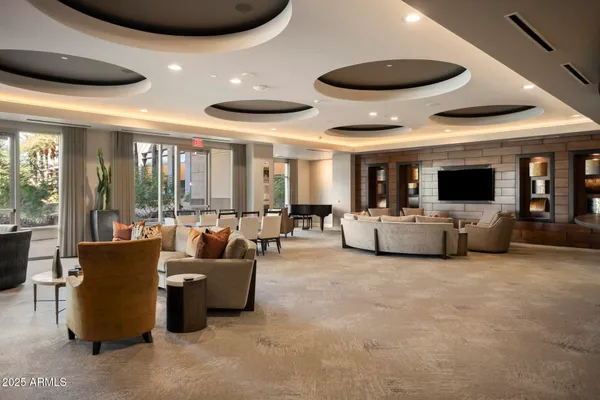 a living room with couches and a flat screen tv
