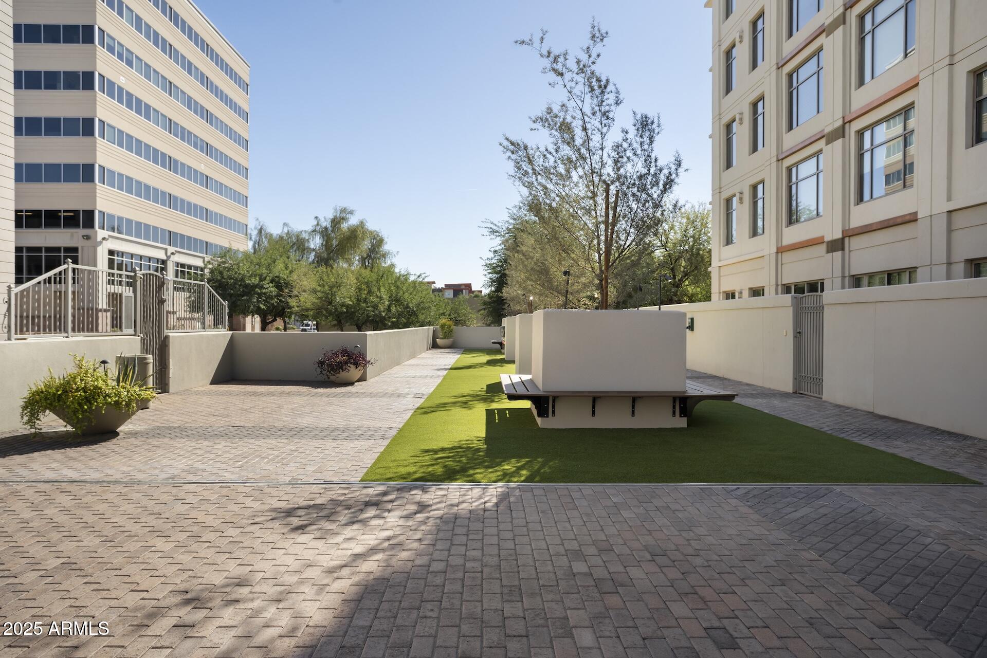2211 East Camelback Road, Unit 1203 Phoenix, AZ 85016 - Photo 36 of 39 a view of backyard with a tub and potted plants