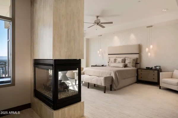a large bedroom with a bed and large windows