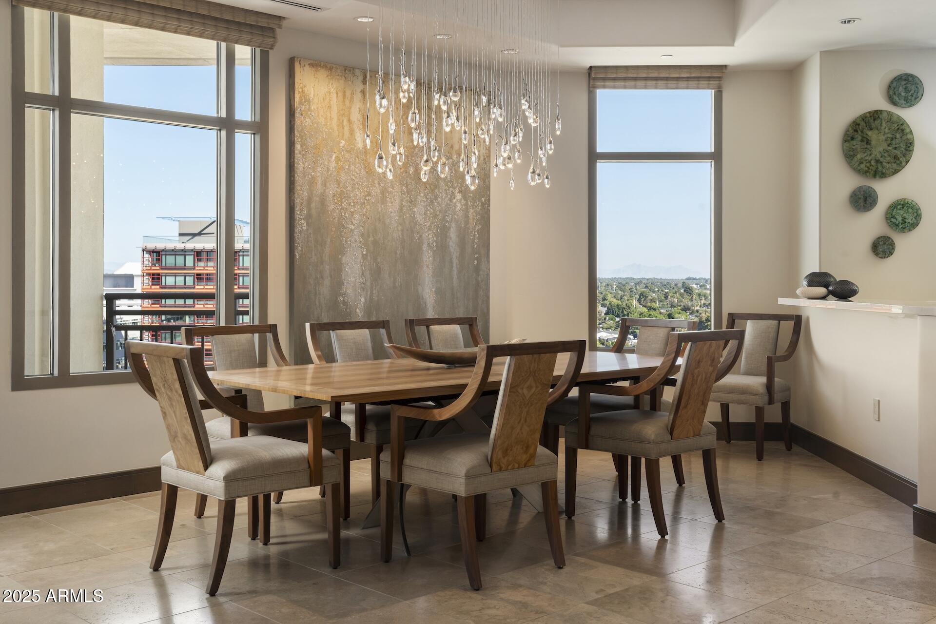 2211 East Camelback Road, Unit 1203 Phoenix, AZ 85016 - Photo 7 of 39 a view of a dining room with furniture and a large window