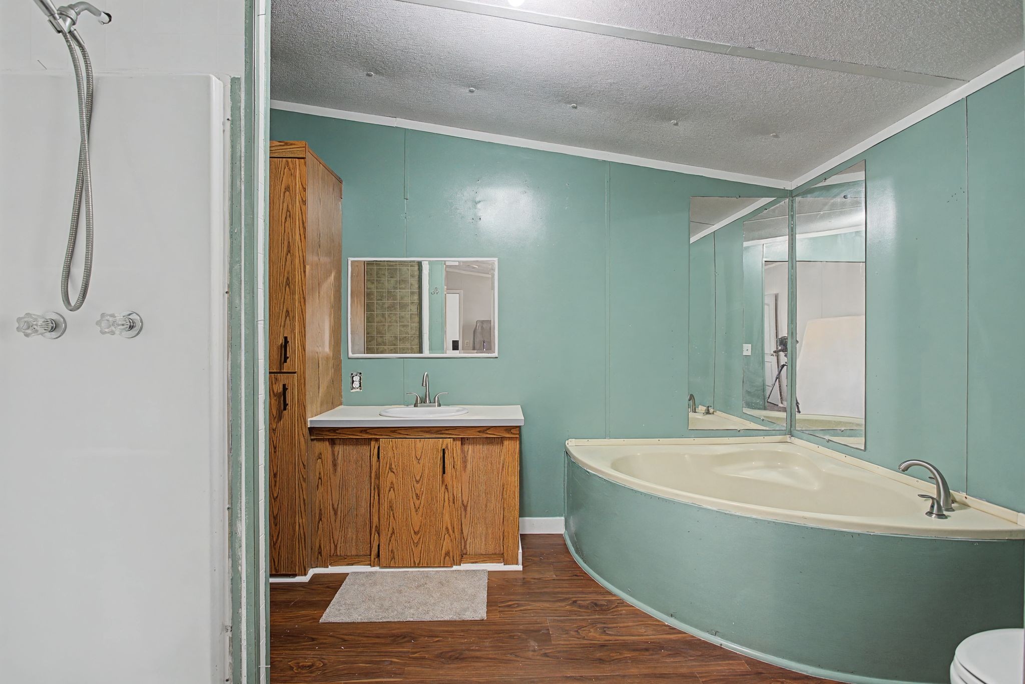 405 Napier Road Hohenwald, TN 38462 - Photo 12 of 37 a bathroom with a tub and shower