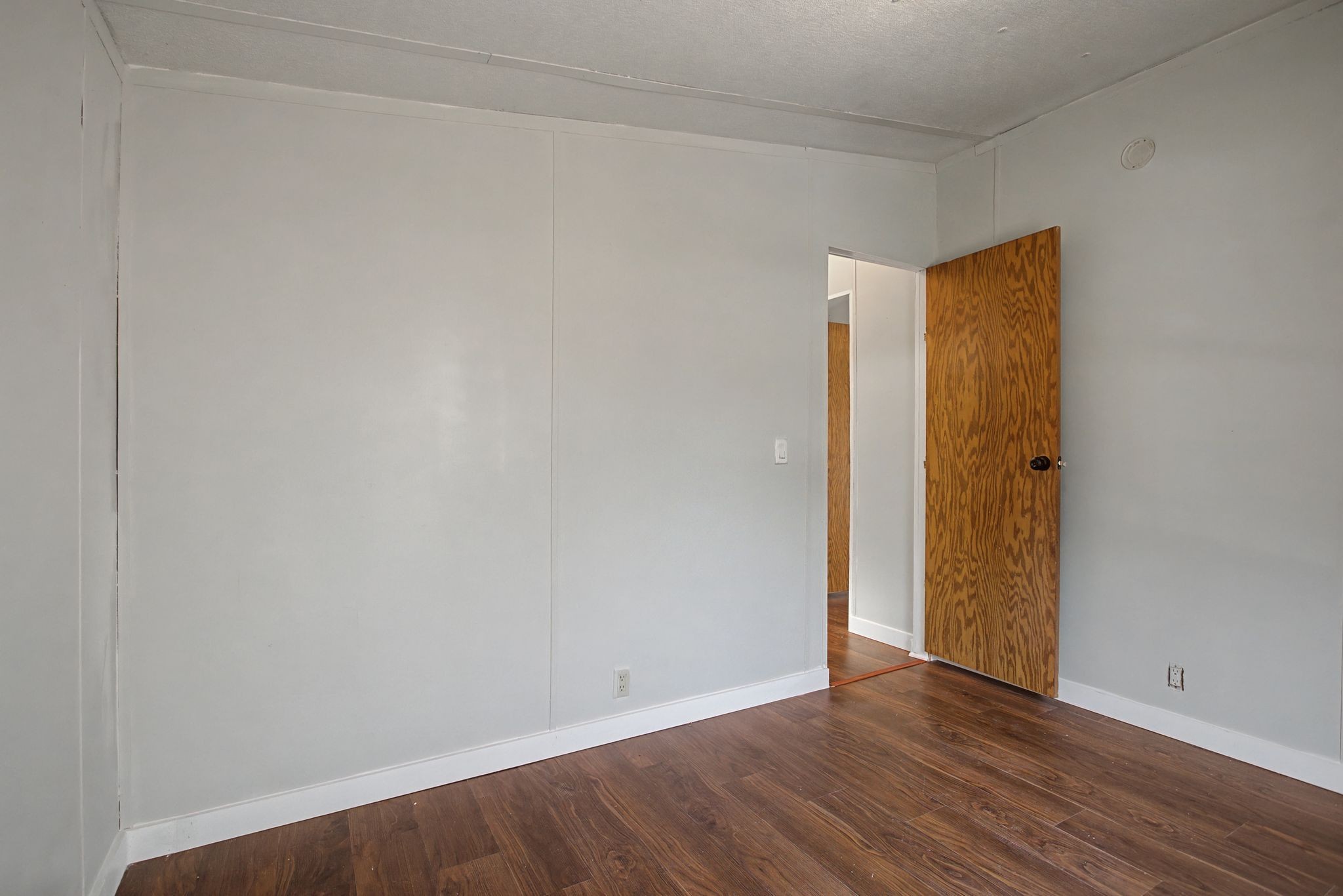 405 Napier Road Hohenwald, TN 38462 - Photo 13 of 37 a view of an empty room with wooden floor and closet