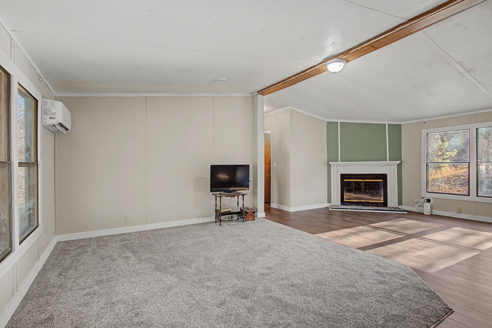 405 Napier Road Hohenwald, TN 38462 - Photo 2 of 37 a view of an empty room with a fireplace and a window