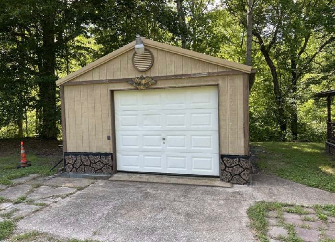 405 Napier Road Hohenwald, TN 38462 - Photo 30 of 37 a front view of a house with garden