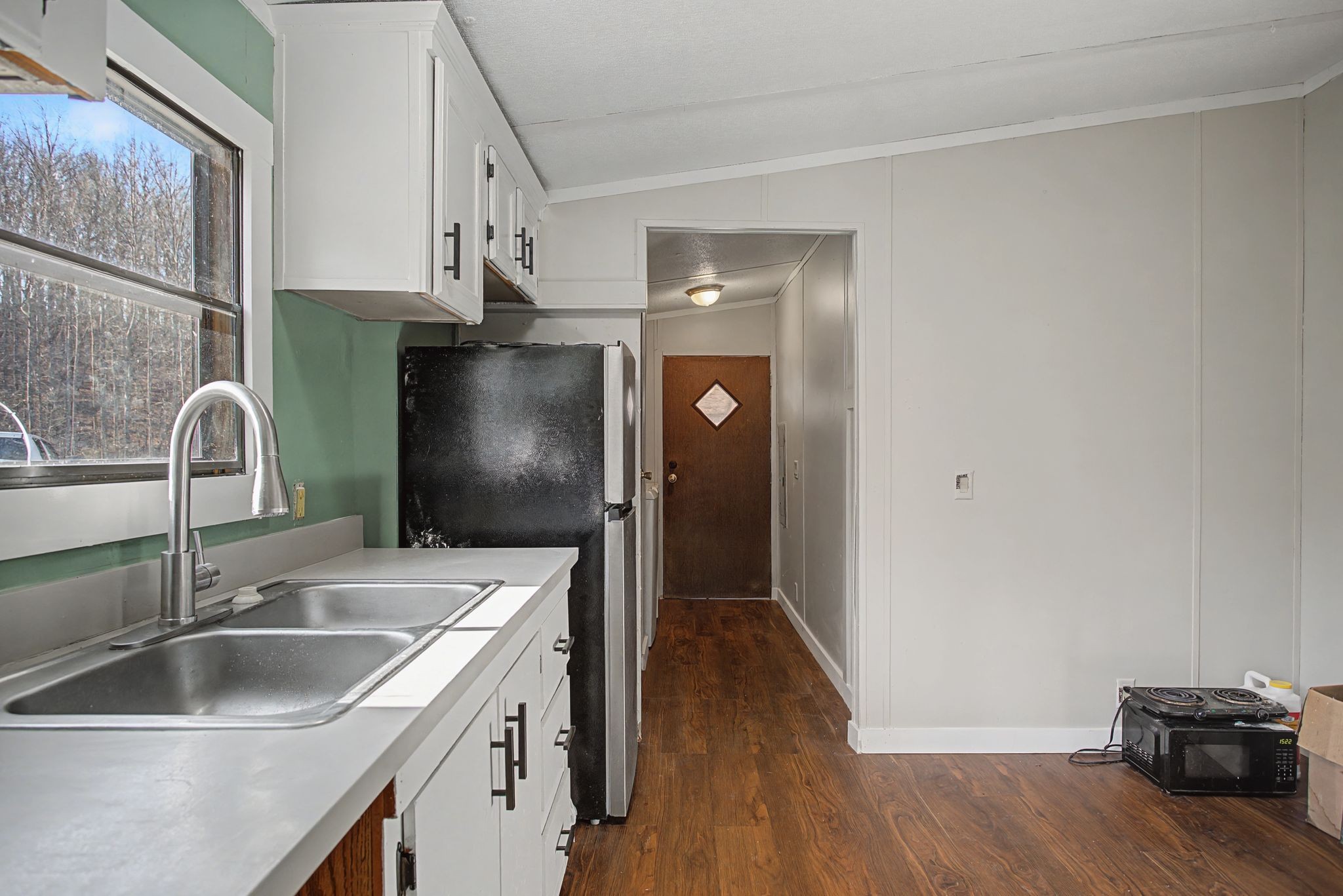 405 Napier Road Hohenwald, TN 38462 - Photo 4 of 37 a kitchen with a sink and a refrigerator