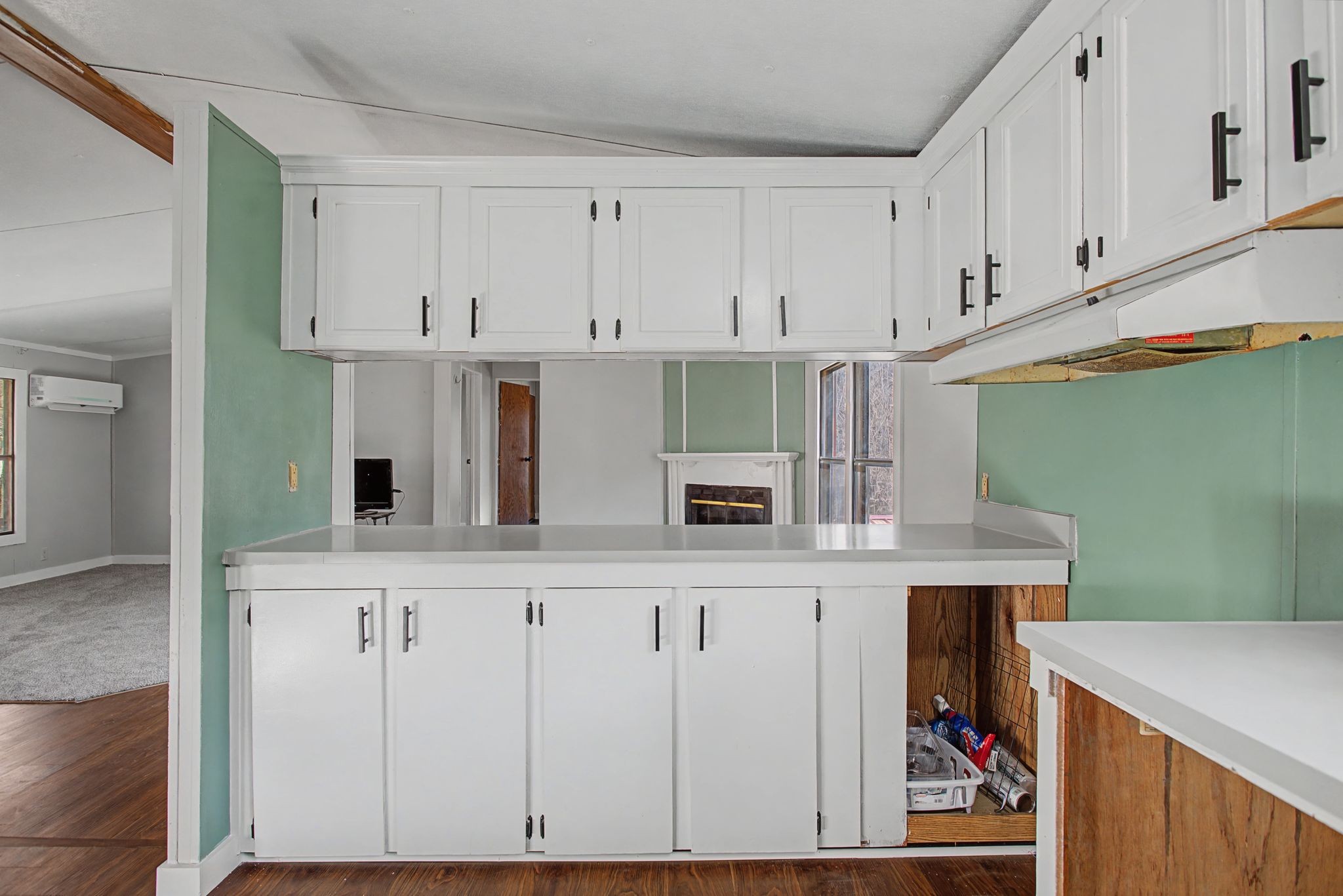 405 Napier Road Hohenwald, TN 38462 - Photo 5 of 37 a kitchen with white cabinets and white appliances