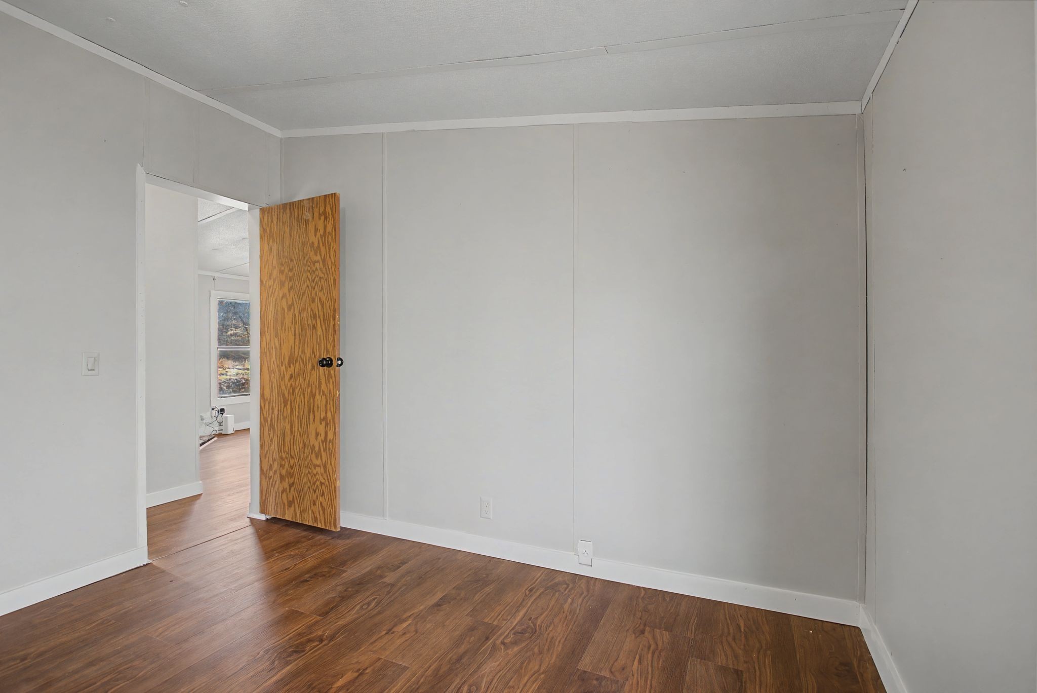 405 Napier Road Hohenwald, TN 38462 - Photo 7 of 37 a view of an empty room with wooden floor